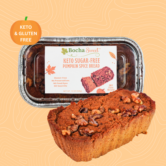 Front view of BochaSweet Keto Sugar-Free Pumpkin Spice Bread in foil loaf pan with labeled packaging showing product name, ingredients, and net carbs
