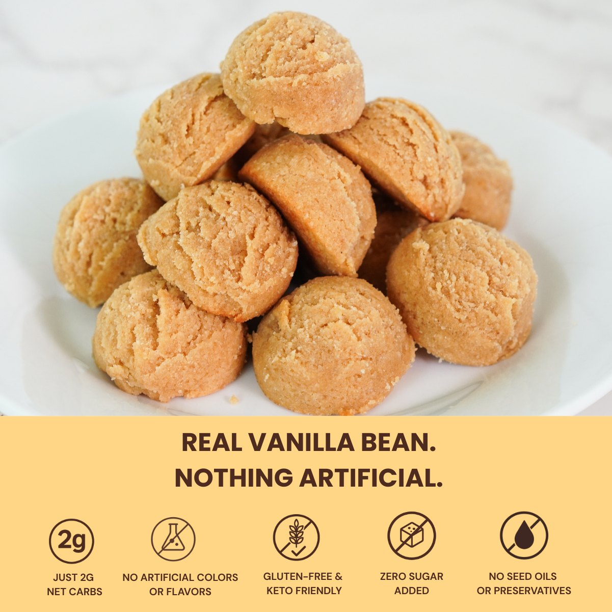 Pile of vanilla-flavored cookies on a white plate with a yellow label detailing nutritional and health benefits.
