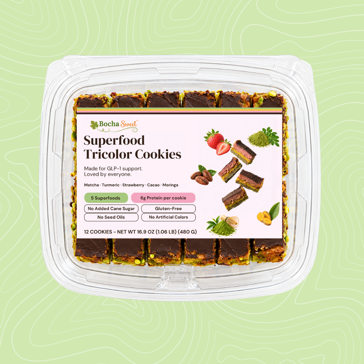 BochaSweet Superfood Tricolor Cookies, 12 layered chocolate-topped cookies in a clear clamshell on a light green background. The label highlights 5 superfoods (matcha, turmeric, strawberry, cacao, and moringa), 6g protein per cookie, no added cane sugar, and gluten-free.